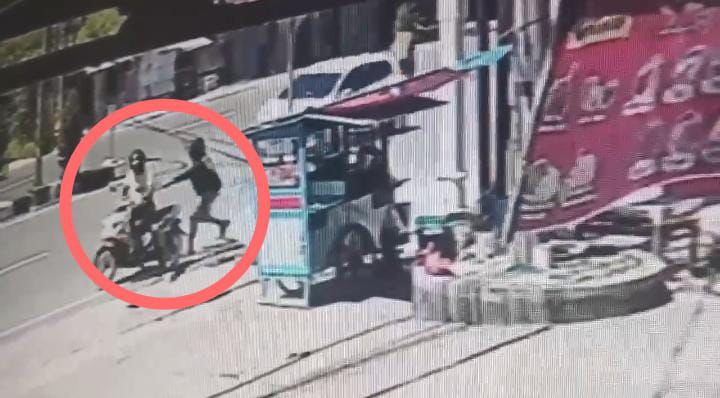 Tangkapan layar CCTV detik-detik dramatis saat pelaku pencurian menyambar tas pedagang sate di kawasan Jelutung, Kota Jambi. (Dok. SS CCTV)