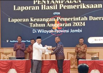 Bupati Kerinci Monadi menerima langsung opini Wajar Tanpa Pengecualian (WTP) atas LKPD 2024 dari Kepala BPK Perwakilan Provinsi Jambi, Muhamad Toha Arafat, di Auditorium Sultan Thaha, Senin (16/6/2025). (Dok. Kominfo)
