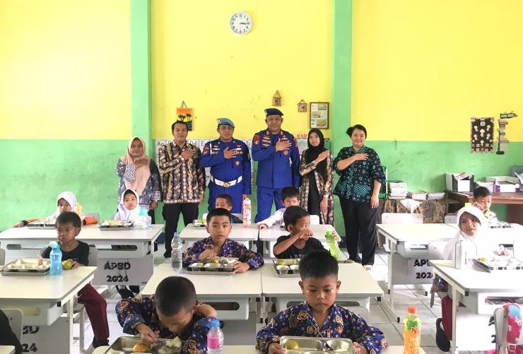 Anggota Ditpolairud Polda Jambi bersama guru dan siswa SDN 73/IV Cempaka Putih saat pelaksanaan Program Makan Bergizi Gratis (MBG), Kamis (24/7/2025). (Dok. Stepanus)