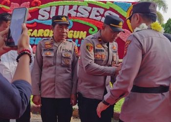 Kapolres Sarolangun yang lama, AKBP Budi Prasetya, menerima penghormatan terakhir dalam tradisi Pedang Pora sebelum resmi menyerahkan jabatan kepada AKBP Wendi Oktariansyah. (Dok. Humas )