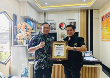 Ketua Persatuan Wartawan Indonesia (PWI) Kota Jambi Irwansyah memberikan penghargaan kepada Dirresnarkoba Polda Jambi Kombes Pol Dr Ernesto Saiser, di ruang kerjanya, Jum’at (04/7/2025). (Dok. Nahar)