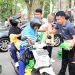 Petugas membagikan beras SPHP kepada warga dalam Gerakan Pangan Murah yang digelar Polda Jambi di kawasan Tugu Keris, Kota Jambi, Minggu (10/8/2025). (Dok.Nahar)
