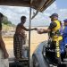 Personel Ditpolairud Polda Jambi menyerahkan bantuan makanan kepada warga pesisir Sungai Batanghari, Jumat (1/8/2025). (Dok. Humas)