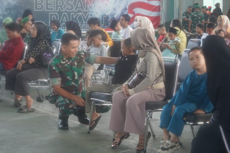 Seorang prajurit TNI berbincang dengan warga saat pelaksanaan bakti kesehatan dalam rangka HUT ke-80 TNI di Lapangan Tenis Indoor Korem 042/Gapu, Jambi, Minggu (21/9/2025). (Dok. Nahar)