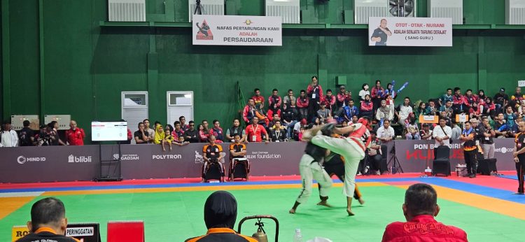 Atlet Tarung Derajat asal Jambi, Gilang Despriyanto (celana putih, pelindung hitam), saat melancarkan serangan terhadap lawannya dari Banten pada babak semifinal kelas 75,1–80 kg putra di GOR Djarum, Kudus, Jawa Tengah, Rabu (15/10/2025). (Dok. Koni Jambi)