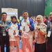 Atlet tarung derajat asal Jambi, Gilang Despriyanto dan Rahma Tia (tengah), berfoto bersama pelatih dan ofisial usai meraih medali perak dan perunggu pada ajang PON Bela Diri 2025 di GOR Djarum, Kaliputu, Kudus, Jawa Tengah, Kamis (16/10/2025). (Dok. Koni Jambi)