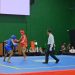 Atlet wushu Jambi (merah) menghadapi lawannya dalam nomor sanda pada PON Bela Diri 2025 di GOR Djarum, Kaliputu, Kudus, Jawa Tengah, Jumat (24/10/2025). (Sok.. Humas KONI Jambi)