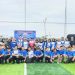 Kalapas Perempuan Kelas IIB Jambi, Meita Eriza, bersama peserta dari BNN Provinsi Jambi dan Bank BRI berfoto bersama usai pembukaan Turnamen Mini Soccer dan Senam Bersama di Lapangan Jambi Mini Soccer, Kabupaten Muaro Jambi, Sabtu (25/10/2025). (Dok. Daus)
