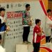 Atlet wushu asal Jambi, Carlson Ong (tengah), menerima medali perunggu pada ajang Pekan Olahraga Pelajar Nasional (POPNAS) XVII 2025 di Jakarta. (Dok. Humas POPNAS XVII 2025)