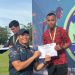 Ade Mardian Syahputra (kanan) menerima piagam penghargaan usai menjuarai nomor lari 100 meter dan 200 meter dalam Jambi Open Athletics Championship 2025 di Stadion Tri Lomba Juang KONI Jambi, Jumat (21/11/2025). (Dok. Daus)