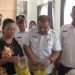 Kepala Dinas Ketahanan Pangan Kabupaten Tanjung Jabung Timur, Nasrul Efendi, bersama warga memeriksa paket bantuan beras dan minyak goreng dari Bapanas pada penyaluran bantuan pangan alokasi Oktober–November 2025. (Dok. Stepanus)