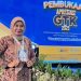 Kepala SMKN 2 Kota Jambi, Dr. Woro Handayani, S.Pd., M.Pd. berpose di area panggung pembukaan acara di Jakarta. (Dok. Pribadi)