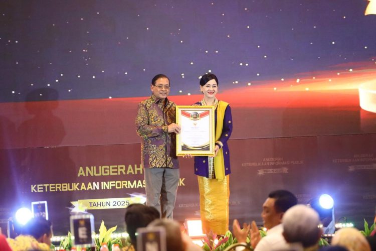 Ketua Komisi Informasi Pusat Donny Yoesgiantoro menyerahkan penghargaan Arkaya Wiwarta Prajanugraha kepada Kepala Eksekutif Pengawas Perilaku Pelaku Usaha Jasa Keuangan, Edukasi, dan Pelindungan Konsumen OJK Friderica Widyasari Dewi pada Anugerah Keterbukaan Informasi Publik Tahun 2025 di Jakarta. (Dok.Humas OJK)