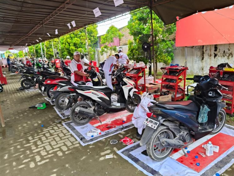 Petugas dan teknisi jaringan sepeda motor Honda melayani servis gratis sepeda motor milik warga terdampak bencana di salah satu pos bengkel AHM di wilayah Sumatera, sebagai bagian dari program pemulihan pascabencana. (Sinsen)