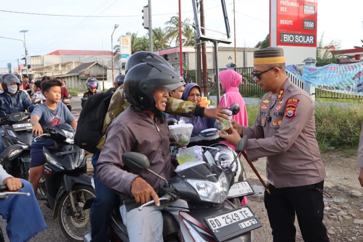 Kapolres Mukomuko, AKBP Riky Crisma Wardana, memimpin langsung kegiatan membagikan lebih dari 100 paket takjil kepada masyarakat, Senin (23/2/2025) sore. (Dok/Dd)