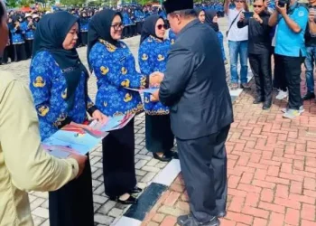 Bupati Mukomuko Choirul Huda menyerahkan 1.873 Surat Keputusan Pegawai Pemerintah dengan Perjanjian Kerja Paruh Waktu secara simbolis di Halaman Kantor Bupati Mukomuko, Selasa (30/12/2025). (Dok:DD)