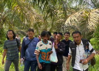 Petugas kepolisian bersama warga mengevakuasi seorang anggota Suku Anak Dalam (SAD) yang sebelumnya dilaporkan hilang usai bentrokan di kawasan PT Sari Aditya Loka (SAL), (Dok. Humas)